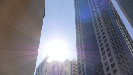 hugh skyscraper on the highway in dubai, shot at a low angle