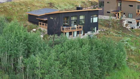 modern contemporary mountain home in the hills black house luxury neighborhood colorado aerial raise reverse