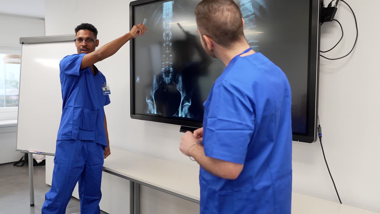 Doctors Discussing X-ray Scan on Digital Screen in Medical Office
