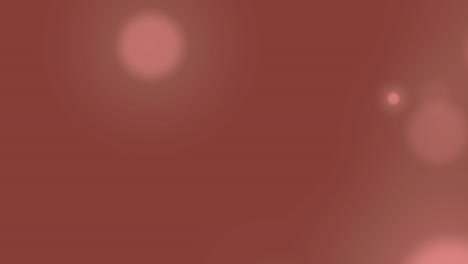 animación de bokeh rosa que se mueve sobre un fondo naranja