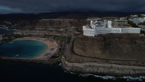 fantastic aerial shot with a general view of amadores beach and the big hotels in the area, during sunset on the island of gran canaria