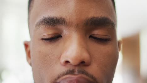 close up of face of african american man opening eyes