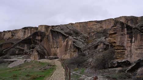 Pan-across-rock-bluff-landscape-of-prehistoric-Gobustan-rock-art-site