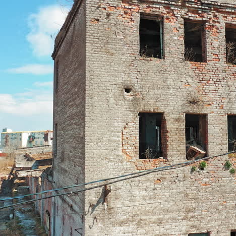 ruined building without windows and roof outside. exterior of a broken-down building in the desolate part of the city.