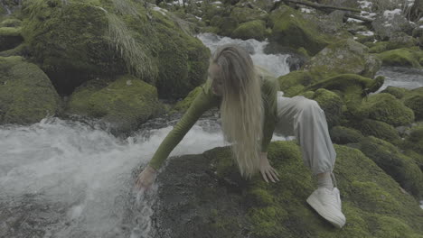 woman by a mountain stream