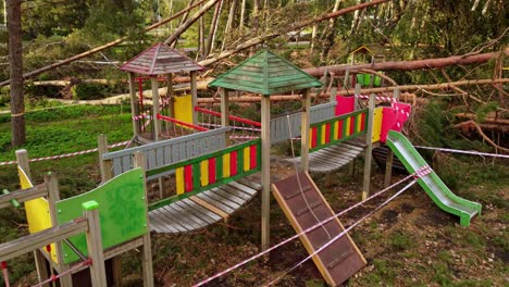 kids playground destroyed by powerful storm with fallen trees, aerial view