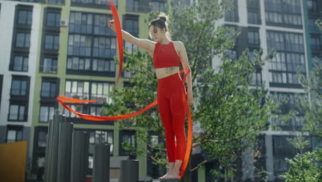 woman ribbon twirling outdoors