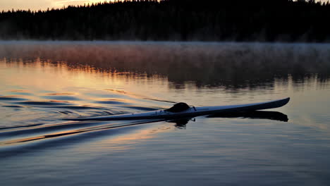 sunrise kayaking on a misty lake