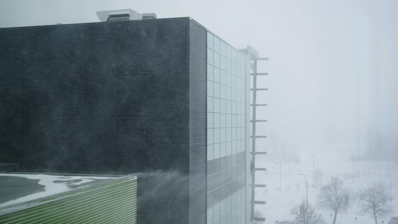 Modern industrial building in heavy snow blizzard