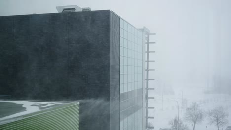 modern industrial building in heavy snow blizzard