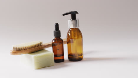 close up of different beauty products on white background with copy space