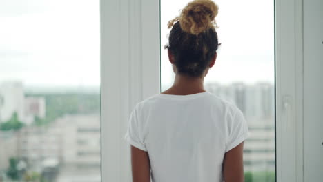 woman looking out a window