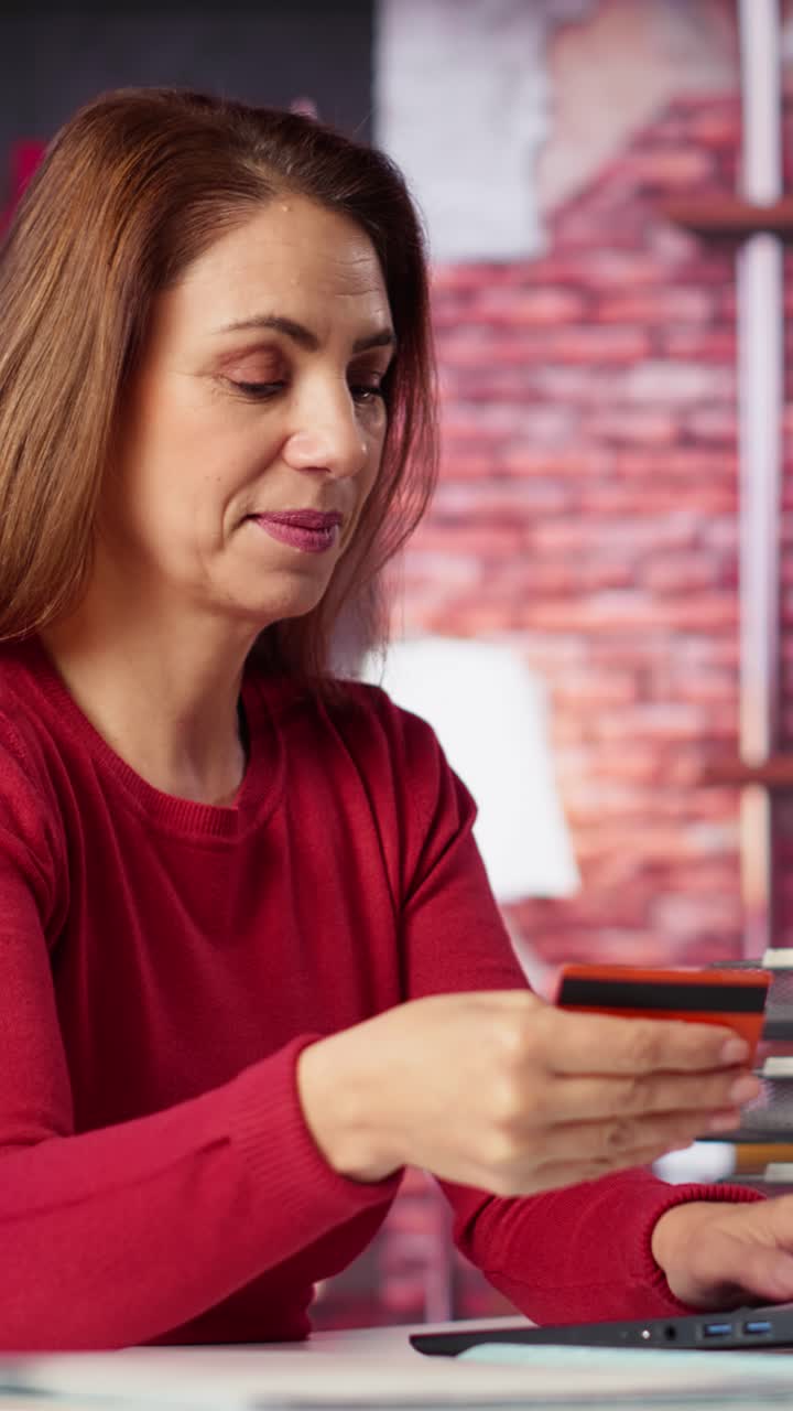 Vertical Video Relaxed woman entering card numbers to verify the balance before paying online