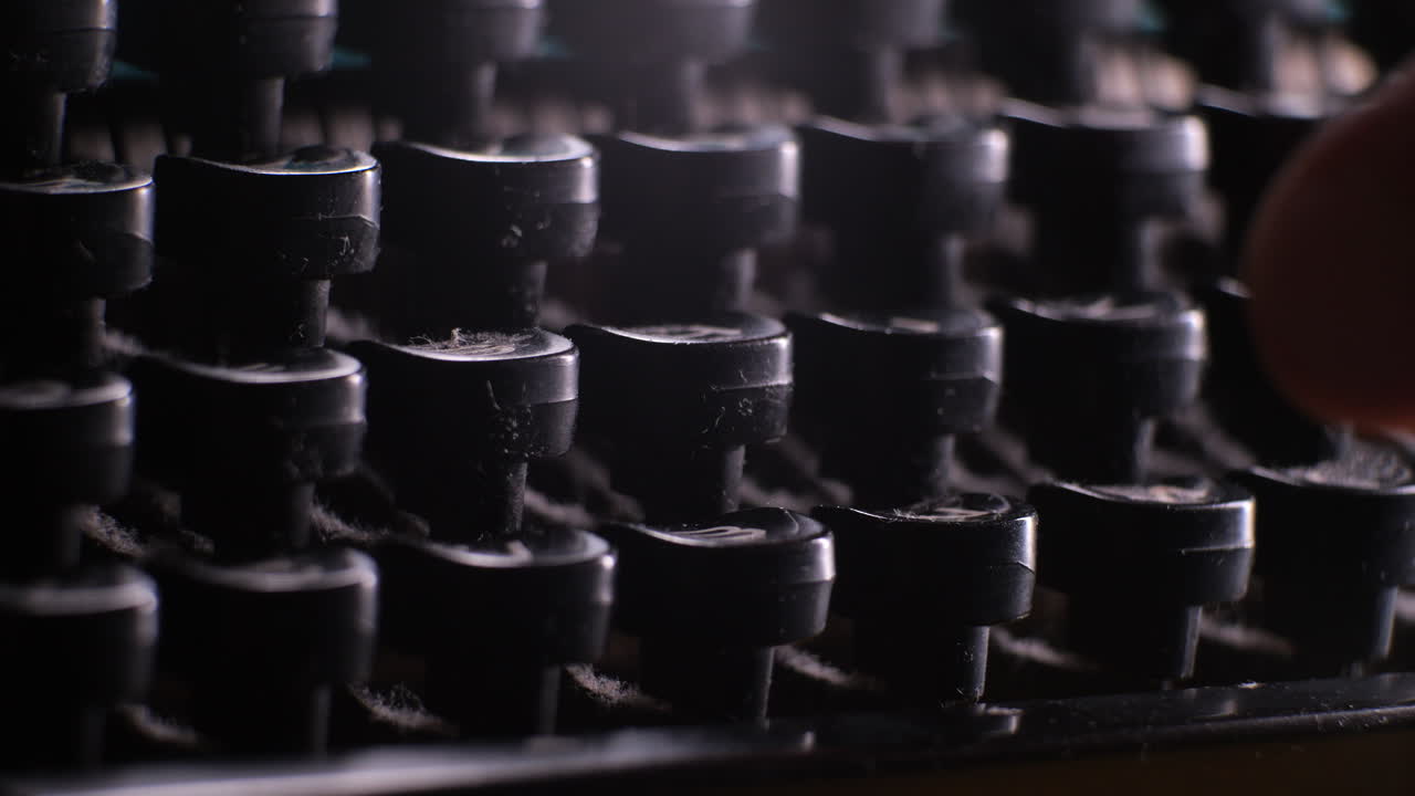 Fingers of person pressing old vintage typewriter buttons, close up view