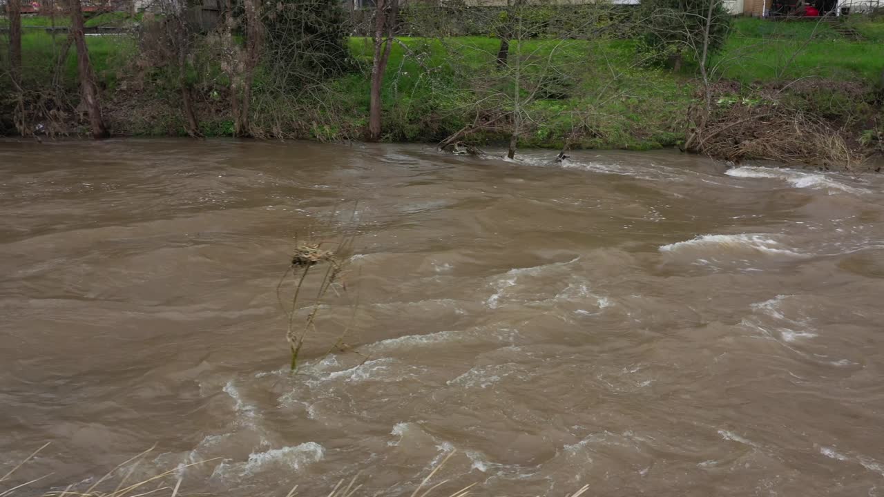 Camera following the flood waters of a creek
