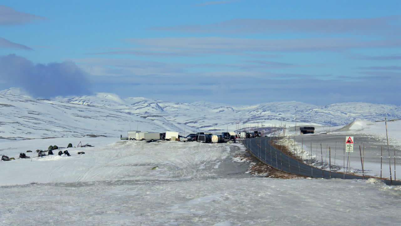 Extra Wide shot looking down the Hardangervidda mountain plateau at Dyranut with the R7 road in April 2025
