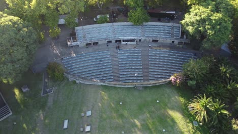 Approaching-aerial-view-of-underground-vacant-amphitheater-at-Centenario-Park,-Buenos-Aires