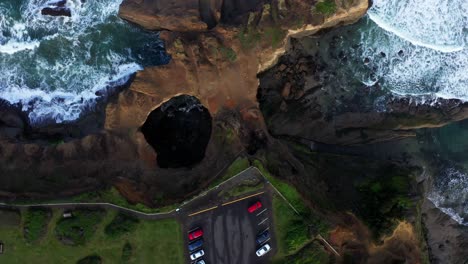 scenic orbital tilt of california rugged rocky terrain coastline and the white waves of the pacific ocean.