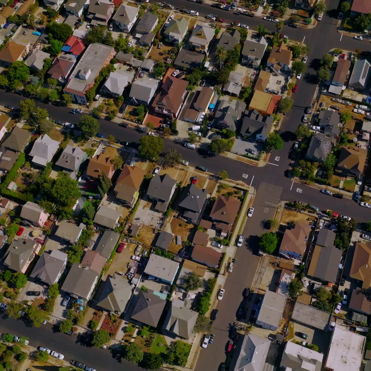 Scenery of residential district in Los Angeles, California, USA. Flying over the roofs of private houses on sunny day. Aerial view