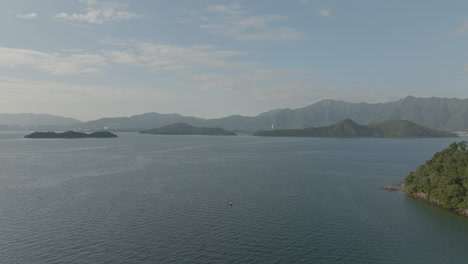 honk kong bay scenic seascape during sunny day of summer with clear sky aerial footage of ocean water with little islet