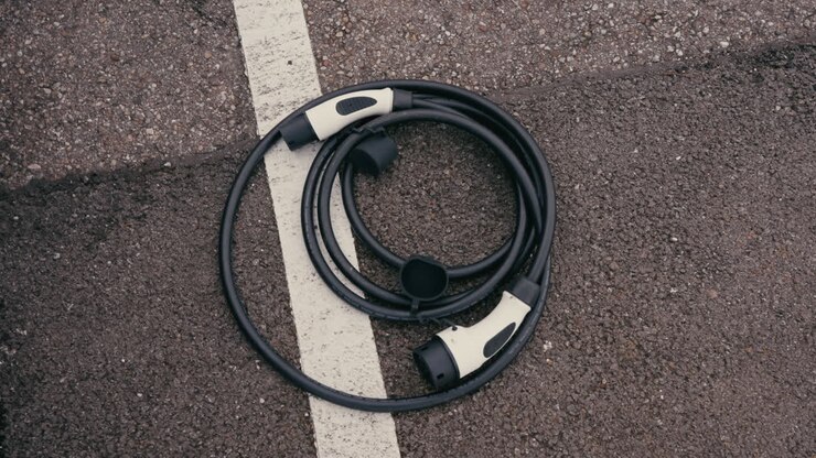Electric Vehicle Charging Cable on Asphalt