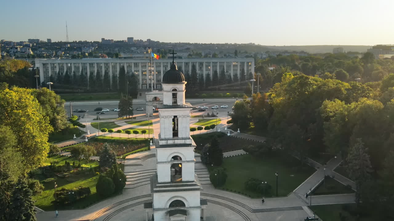 Aerial drone view of Chisinau downtown at sunset. Panorama view of Goverment building, Triumph Arch, bell tower, walking people. Moldova