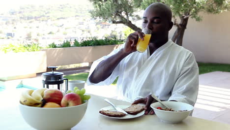 man eating breakfast outdoors