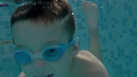 child diving in outdoor swimming pool on resort