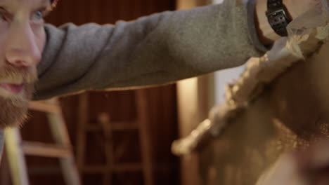 HANDSOME-man-doing-the-clay-details-under-window