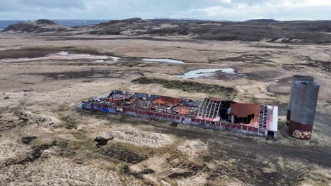 Abandoned-farm-in-Iceland's-wilderness,-featuring-crumbling-structures-and-debris,-demonstrates-nature's-ability-to-reclaim-and-transform-built-up-areas