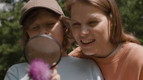 mother and child exploring nature with magnifying glass