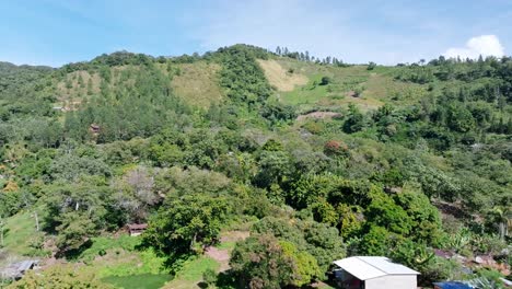 drone flying over farm on green mountains of bonao, dominican republic