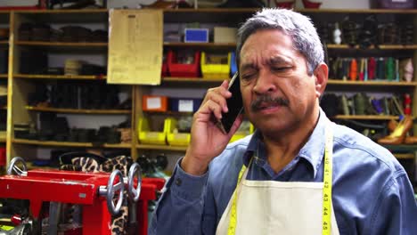 shoemaker talking on the mobile phone