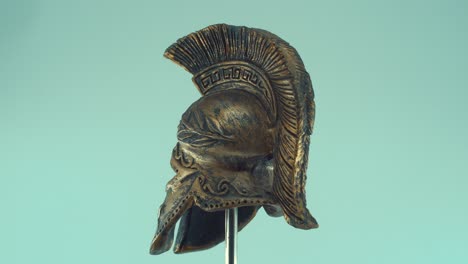 A-rotating-close-up-shot-of-a-spartan-ancient-greek-warrior-metal-bronze-helmet,-with-shapes-and-forms,-studio-lighting,-slow-motion,-4K-video