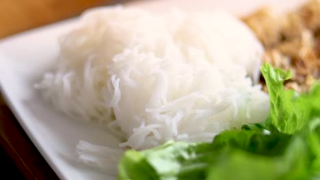 fresh noodles and pork rolls with lettuce