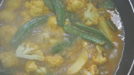 top view of cooking cauliflower vegetable curry in a cooking pan