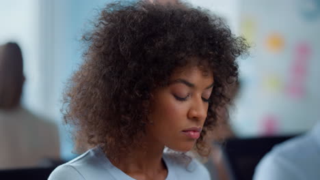 mixed race businesswoman working in office. female executive looking down