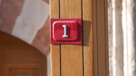number 1 sign on a wooden post