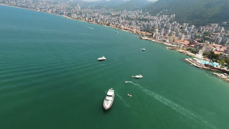 Yacht-And-Sailboats-Floating-In-The-Calm-Waters-Of-Sea-In-Summer-Near-The-Coastal-City