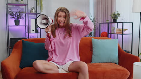 young caucasian woman talking with megaphone, proclaiming news, loudly announcing advertisement