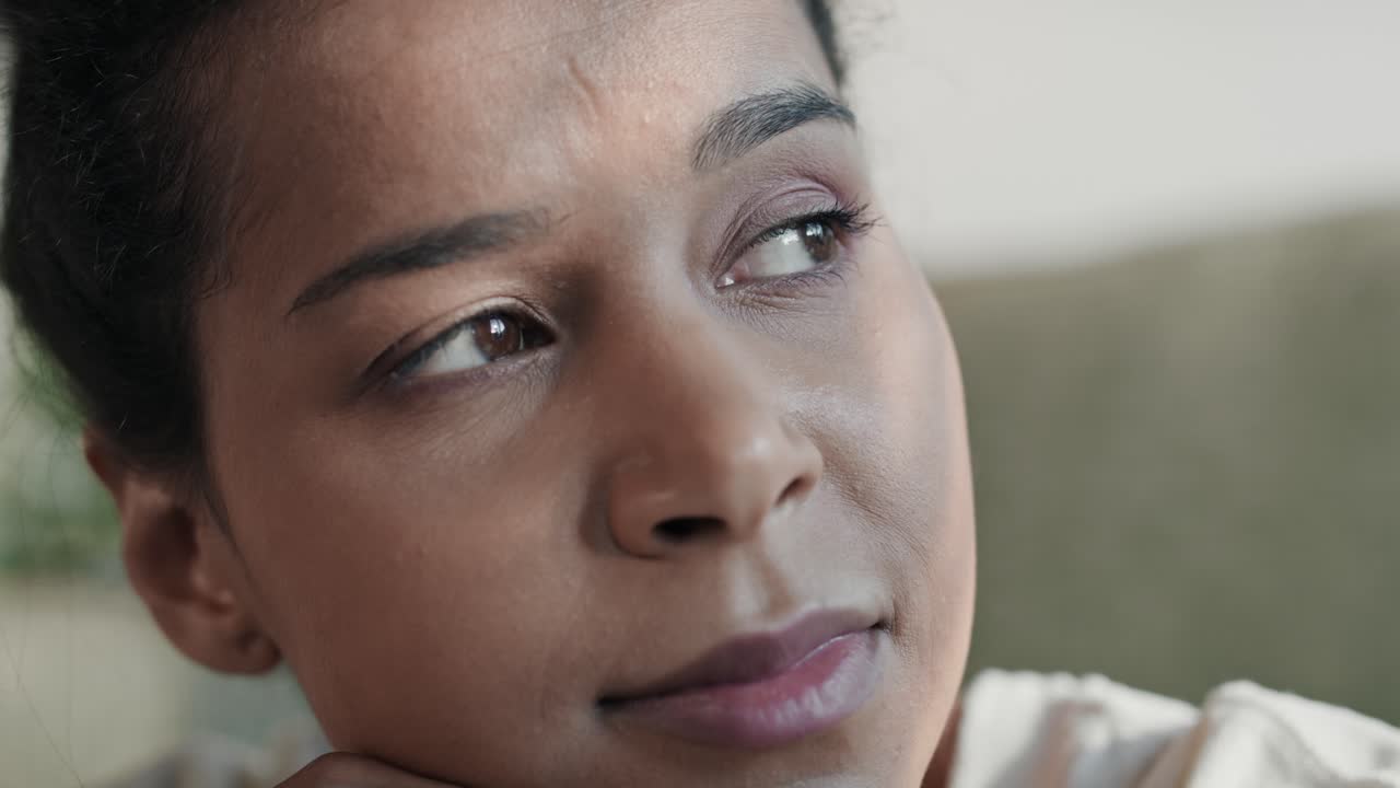 Close up of smiling woman looking away and spending time at home.