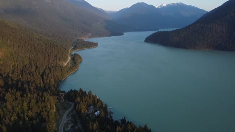 view of lillooet lake with dense conifer forest mountains in british columbia, canada