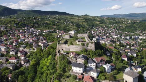Jajce-Fortress-Towering-Over-Town,-Aerial-Panoramic,-Bosnia-and-Herzegovina