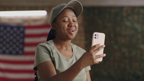 woman in military attire making a video call