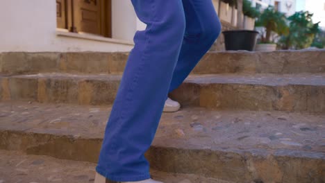 Woman-walks-down-steps-in-high-heels-in-villa-mediterranea