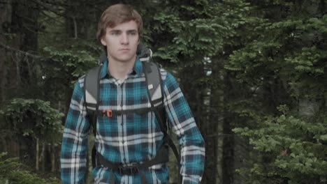white male hiking outdoors on trail up peaceful lush high elevation green forest in the pacific northwest in oregon