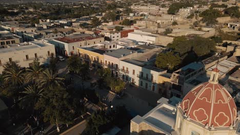 aerial view a the dome of a mexican church in a charming and peaceful town at dawn