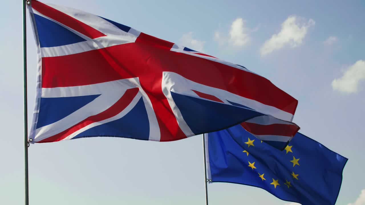 Blue sky and two flags in slow motion