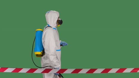 disinfectant worker in a protective white suit, respirator and glasses makes disinfection on isolated green screen chroma key. slow motion. close up