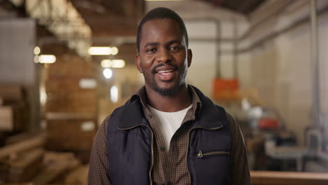 smiling craftsman in a woodworking workshop